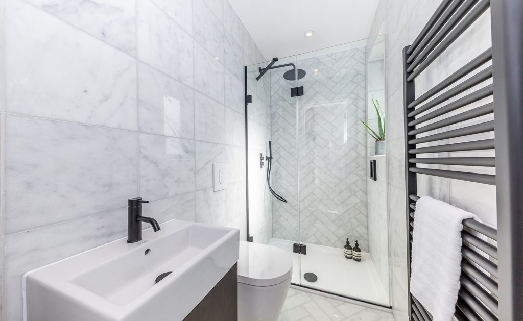 Modern bathroom including sink and shower cubicle at Queen's Wood Apartments | London Penthouse